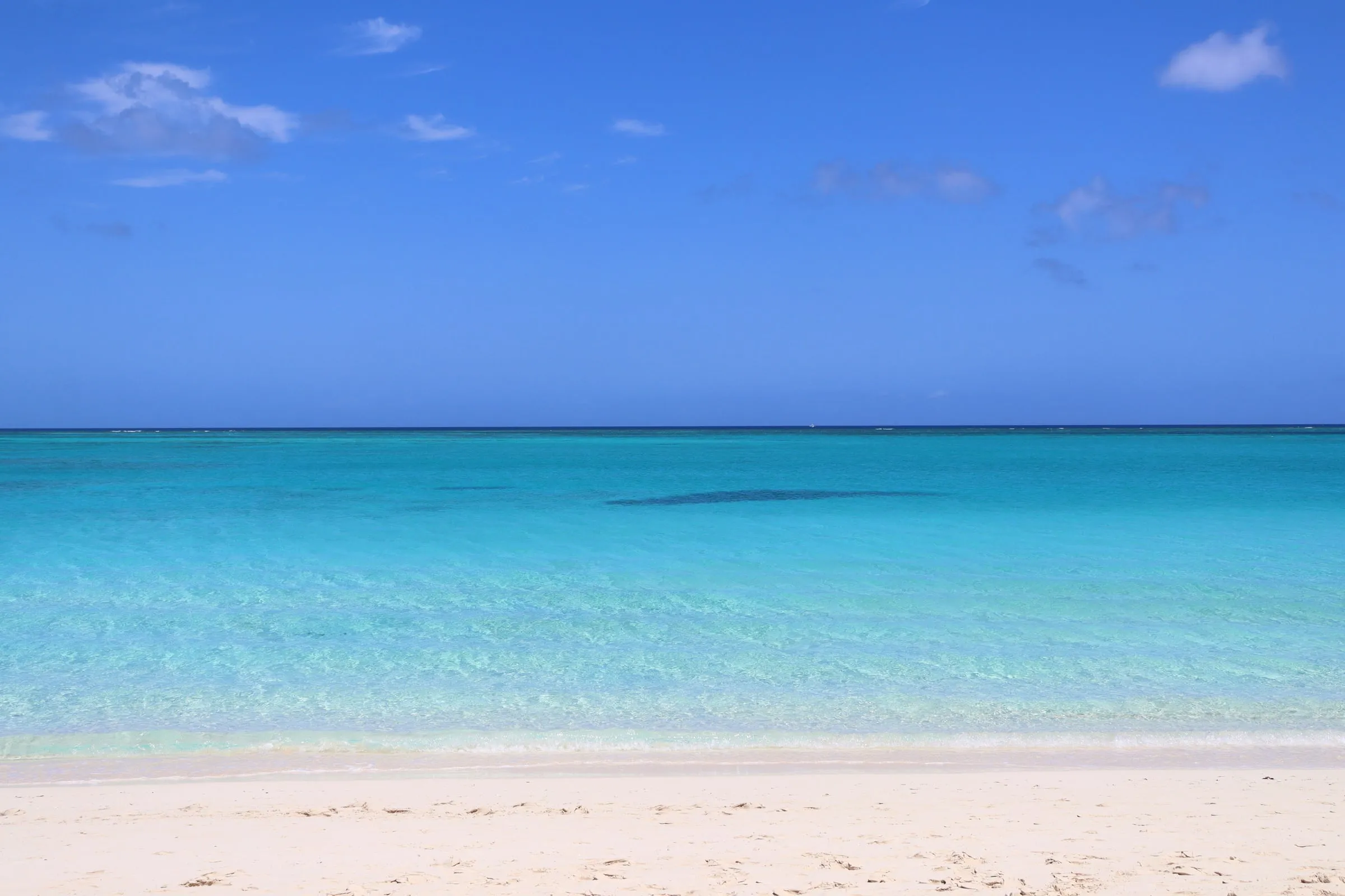Grace Bay Beach: white sand and clear turquoise water under a blue sky