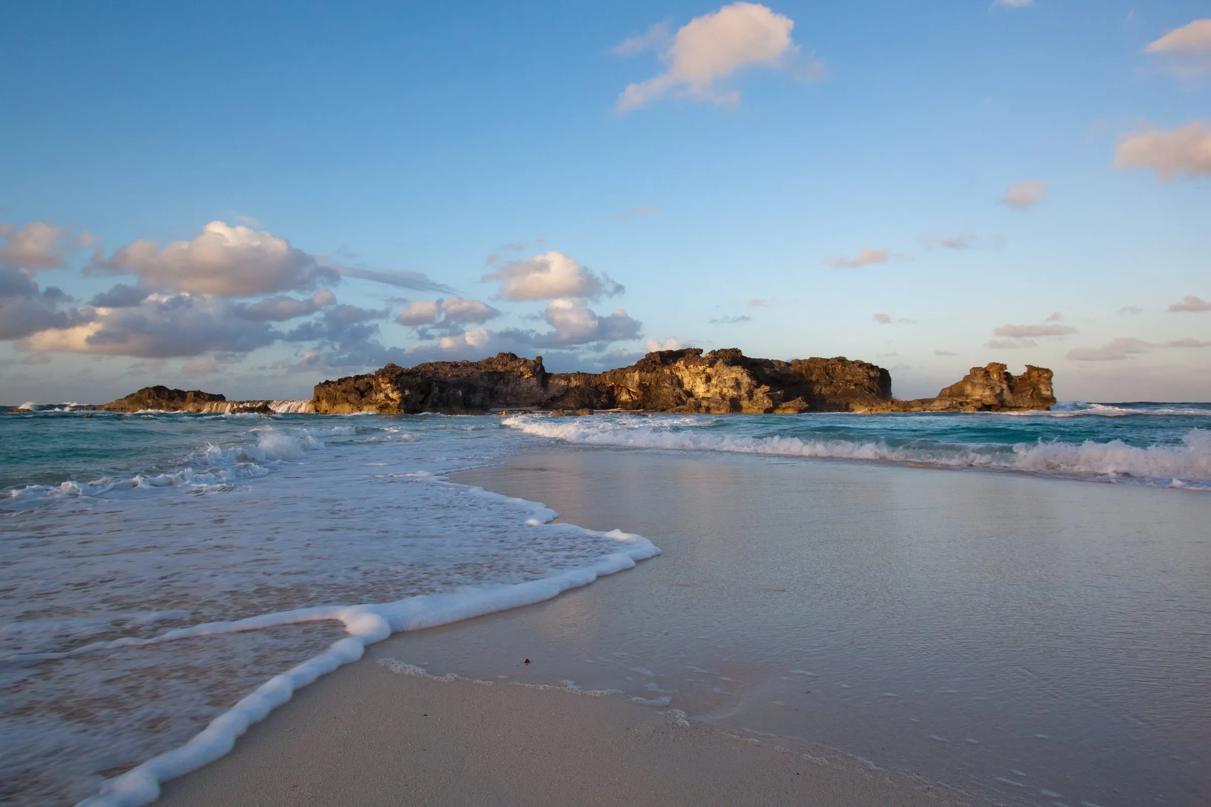 Dragon Cay off Mudjin Harbour, Middle Caicos, in golden evening light with surf on the beach